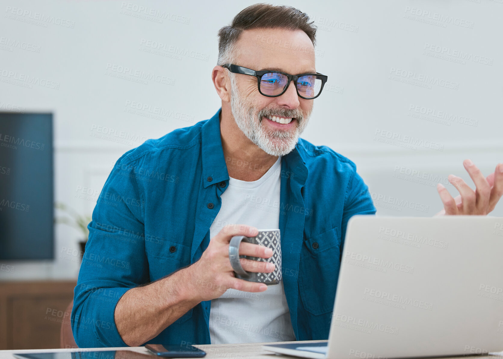 Buy stock photo Shot of a mature businessman working from home using his laptop