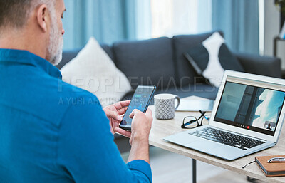 Buy stock photo Shot of a businessman using his laptop while working from home