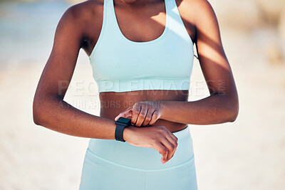 Buy stock photo Shot of an athletic young woman checking her wristwatch
