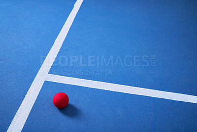 Buy stock photo Single, floor and tennis ball for game or sport, practice and training for skill development for tournament or match. Blue court or pitch, red equipment and ground for athletic activity and fitness.