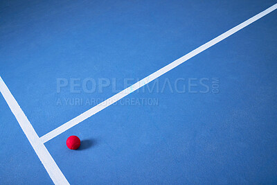 Buy stock photo Single, ground and tennis ball for game or sport, practice and training for skill development for tournament or match. Blue court or pitch, red equipment and floor for athletic activity and fitness.