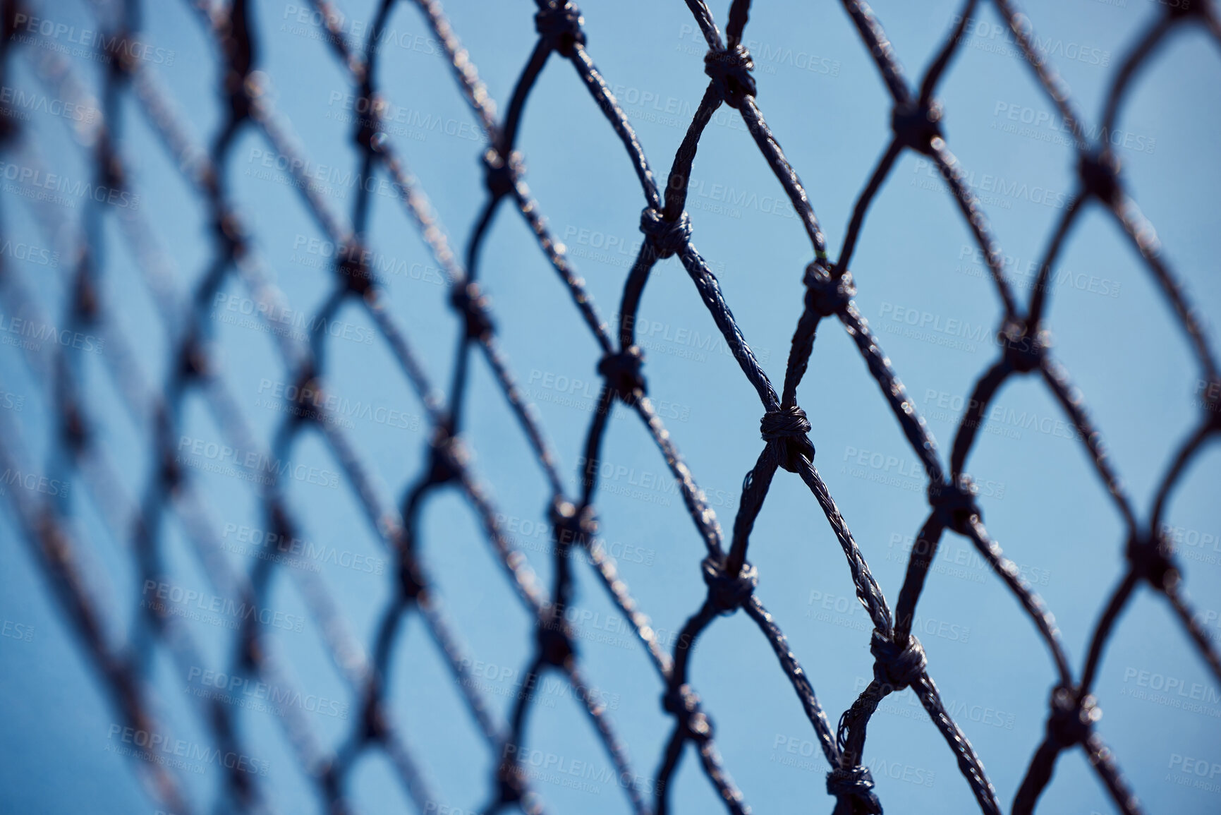 Buy stock photo Shot of a tennis net on an empty court during the day