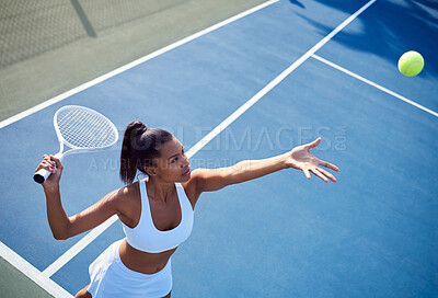 Buy stock photo Shot of an attractive young woman playing tennis outside