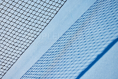 Buy stock photo Shot of a tennis net on an empty court during the day