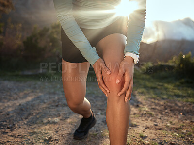 Buy stock photo Shot of a woman massaging her knee after an injury occured