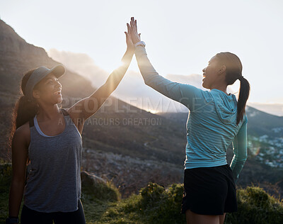 Buy stock photo Shot of two friends high fiving after a run