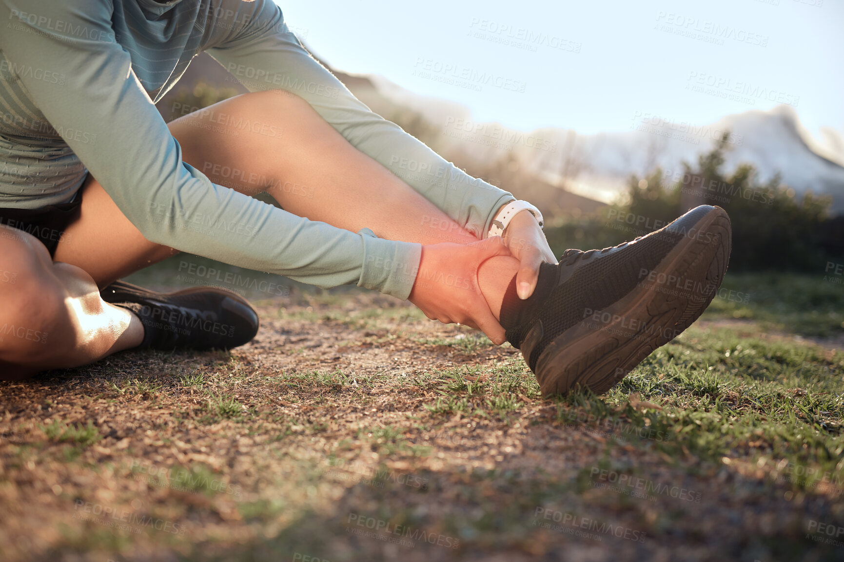 Buy stock photo Outdoor, ankle and pain with hands for fitness, exercise injury and muscle strain in morning by grass. Nature, person or runner and massage for foot ache after training accident, anatomy or arthritis