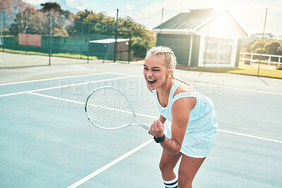 Buy stock photo Shot of an attractive young woman celebrating during a game of tennis