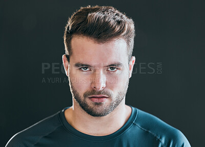 Buy stock photo Cropped portrait of a handsome young male athlete posing against a grey background