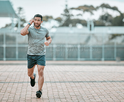Buy stock photo Sports, exercise and man running with earphones for music, radio or podcast for motivation. Fitness, energy and athlete runner doing outdoor cardio workout for race, competition or marathon training.