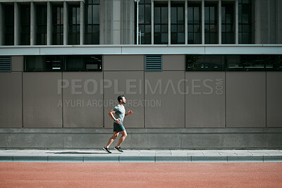 Buy stock photo Shot of a young man going for a morning run