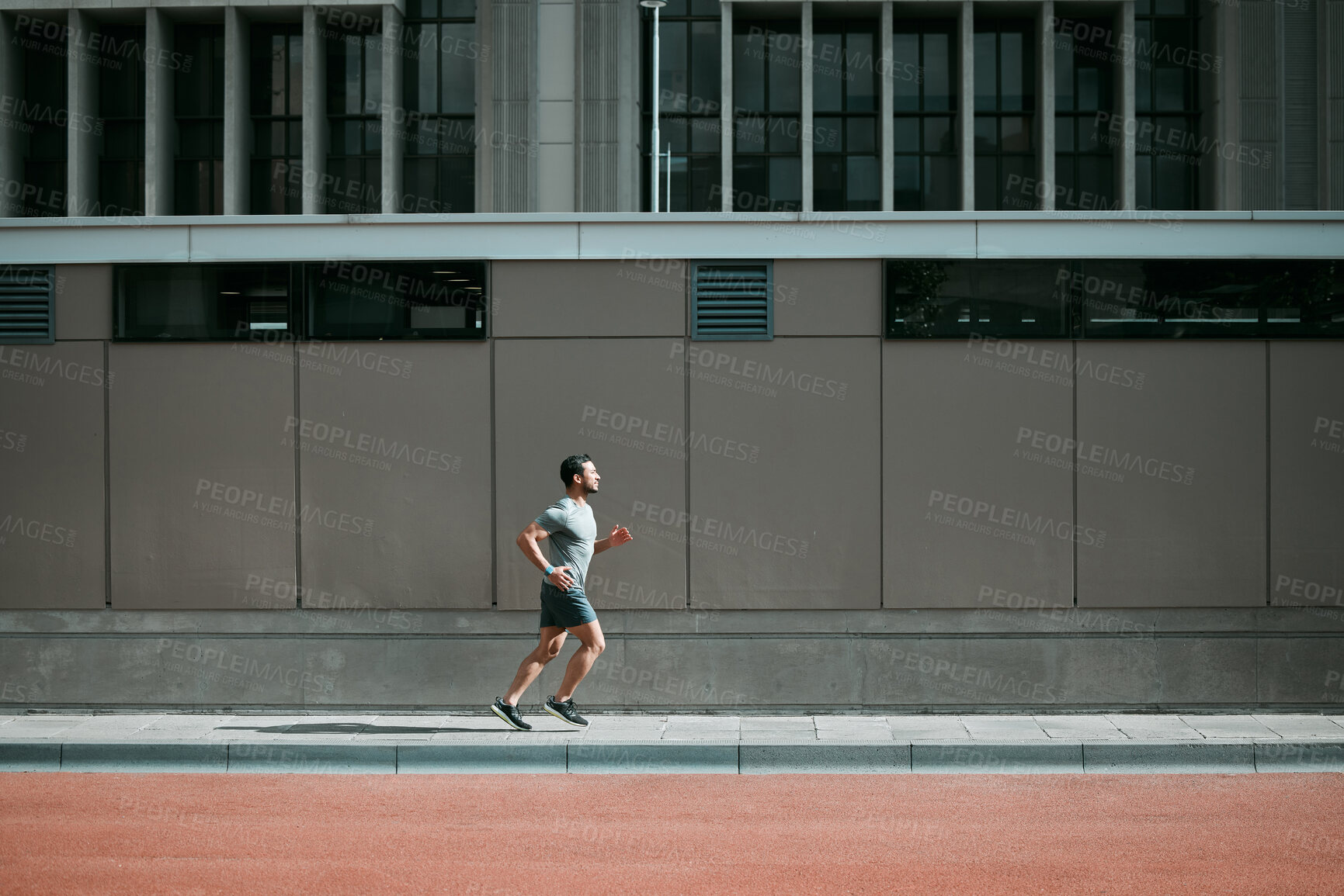 Buy stock photo Man, runner and training by buildings in city, sidewalk and outdoor for speed, workout and development. Person, athlete and prepare on road for challenge in global competition, sports or marathon