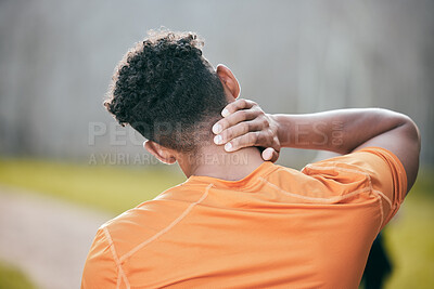 Buy stock photo Shot of an unrecognisable man standing alone and suffering from a neck injury during his outdoor workout