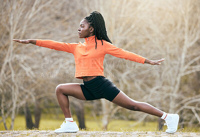 Buy stock photo Full length shot of an attractive young woman standing and stretching before exercising outdoors