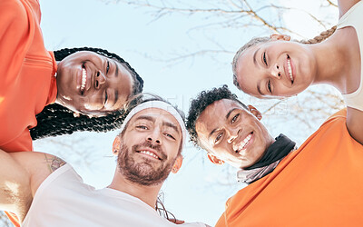 Buy stock photo Low angle shot of a diverse group of friends standing huddled together after their workout