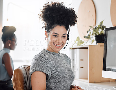 Buy stock photo Portrait of a young call centre agent working in an office with her colleague in the background