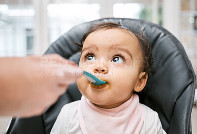 Buy stock photo Shot of a mother feeding her adorable baby girl