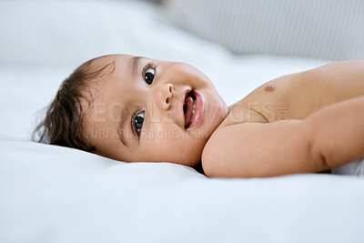 Buy stock photo Shot of an adorable baby girl lying on a bed