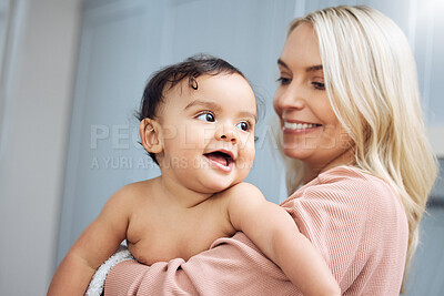 Buy stock photo Love, smile and mother holding with her baby in the nursery room of their modern family home. Happy, bonding and young woman hugging her cute girl infant child with care and affection in their house.