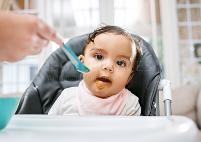 Buy stock photo Shot of a mother feeding her adorable baby girl