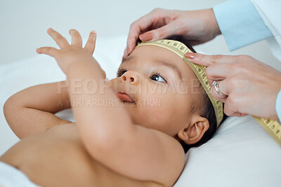 Buy stock photo Woman, hands and measuring tape for baby, growth and brain development in clinic for children. Pediatrician or doctor, infant and wellness for healthcare in hospital with trust for professional care