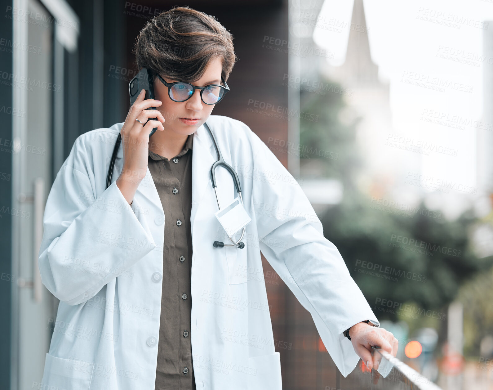 Buy stock photo Woman, serious doctor and phone call at hospital for telehealth, information or service at balcony. Mobile, medical worker and talk to contact for healthcare consultation, advice or listening in city