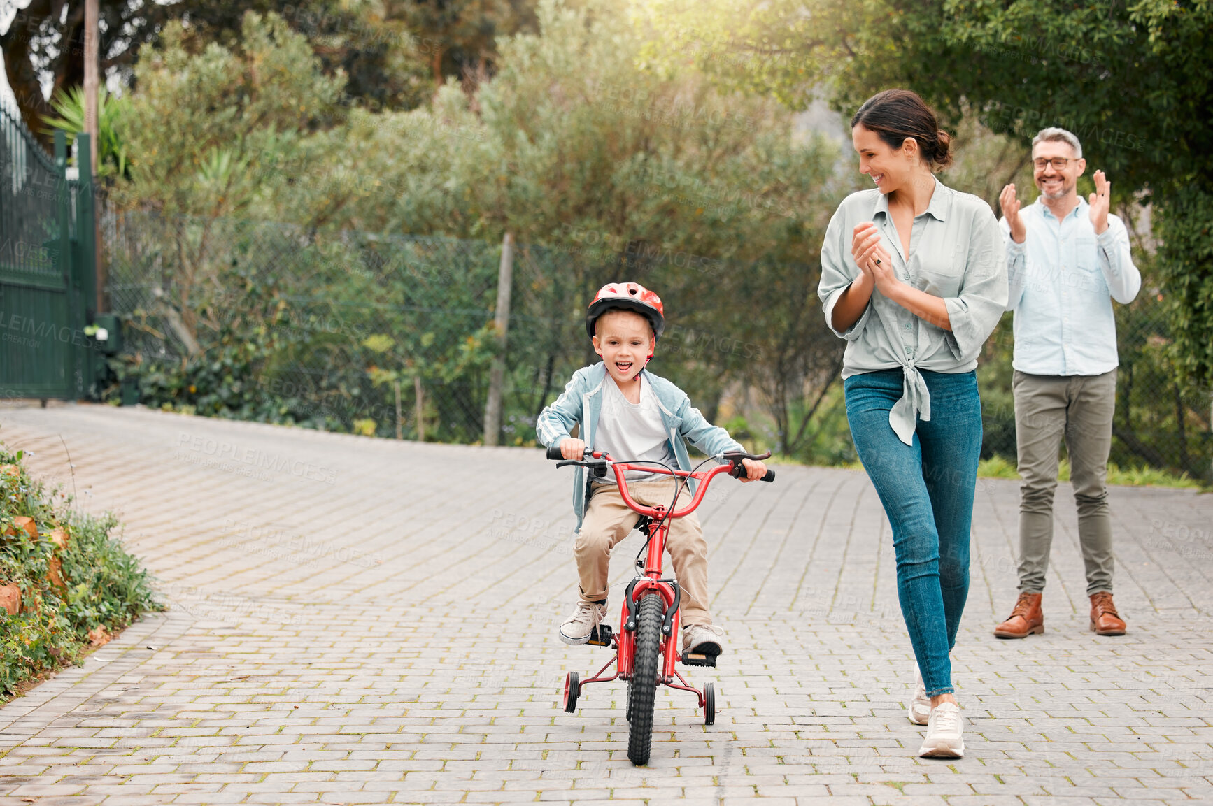 Buy stock photo Parents, son and clapping for biking in outdoor, celebration support and training activity for kid. Family, boy and teaching cycling outside or applause for child development, motivation and safety