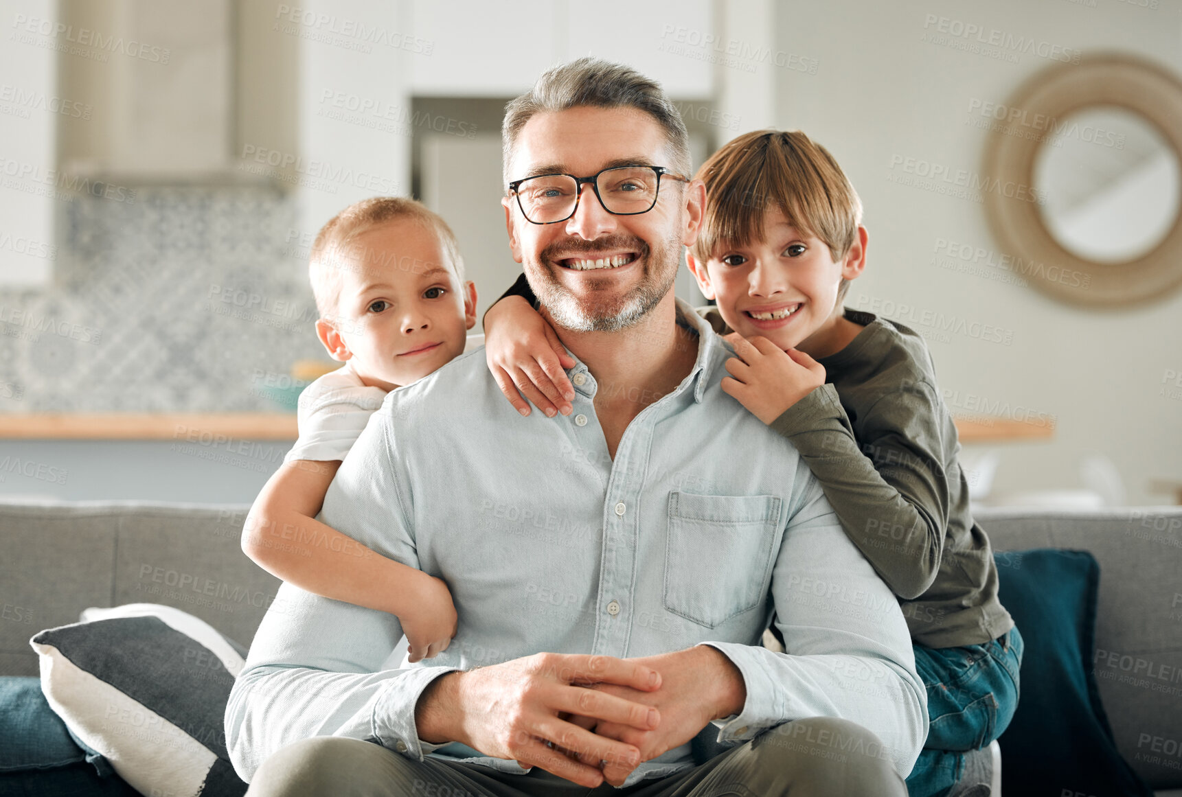 Buy stock photo Dad, kids and hug in home portrait, peace and single parent love for boys in living room. Father, children and embrace for security on couch for care in childhood, relationship and comfortable joy