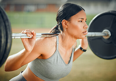 Buy stock photo Cropped shot of an attractive young female athlete exercising with weights outdoors