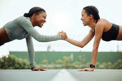 Buy stock photo Cropped shot of two attractive young female athletes shaking hands while planking face to face outside on a sports court