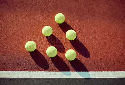 Buy stock photo Shot of tennis balls lying on a court