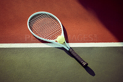 Buy stock photo Shot of a tennis ball and a racket lying on a court