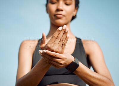 Buy stock photo Shot of a young woman massaging a cramp in her hand