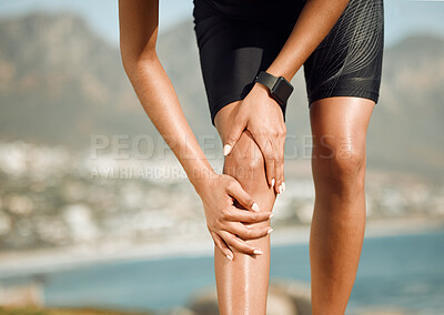 Buy stock photo Shot of a woman massaging her knee during a cramp
