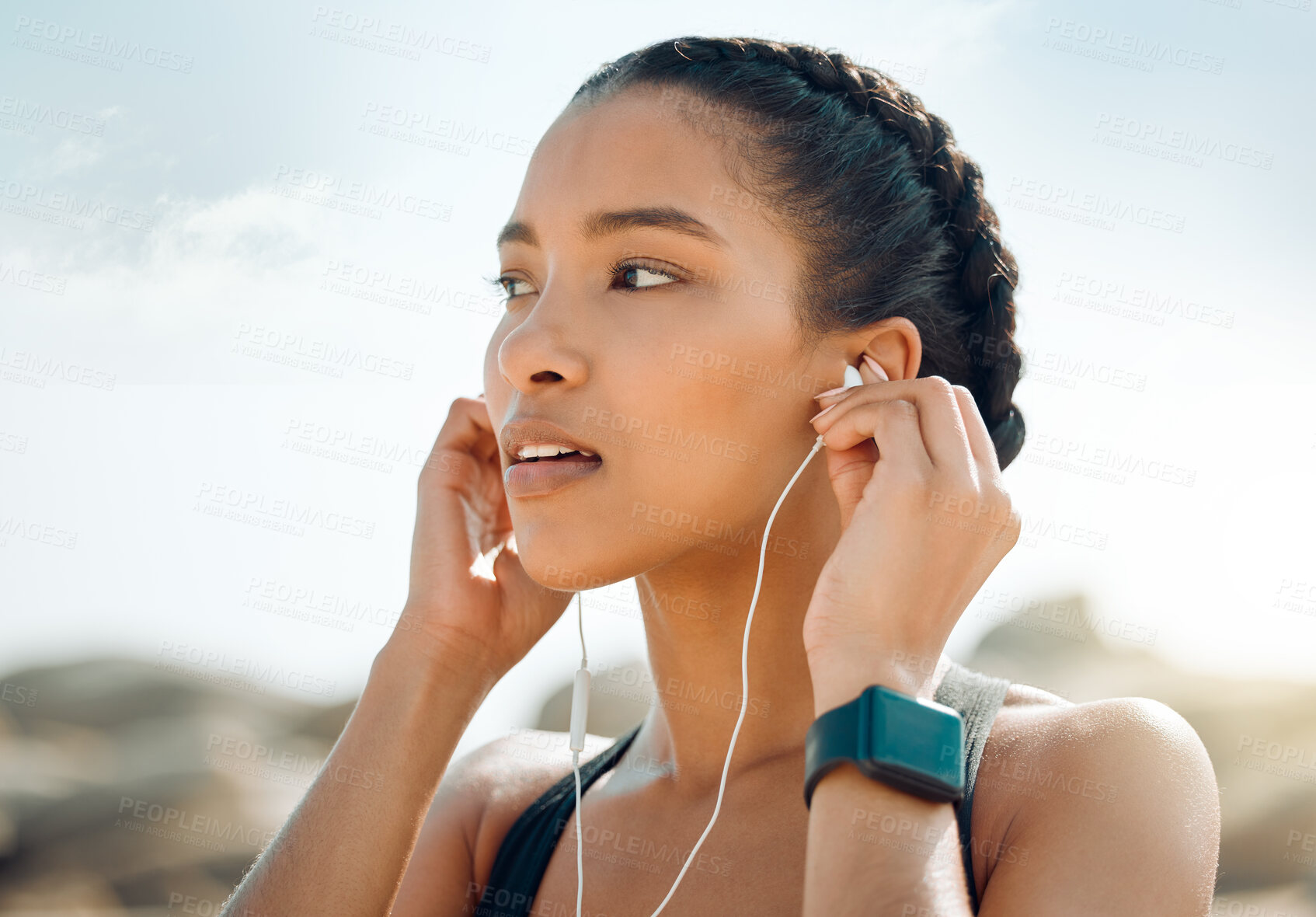 Buy stock photo Woman with earphones, fitness at the beach and listening to music for motivation and workout outdoor. Exercise, health and wellness, female athlete streaming online with radio and audio in nature