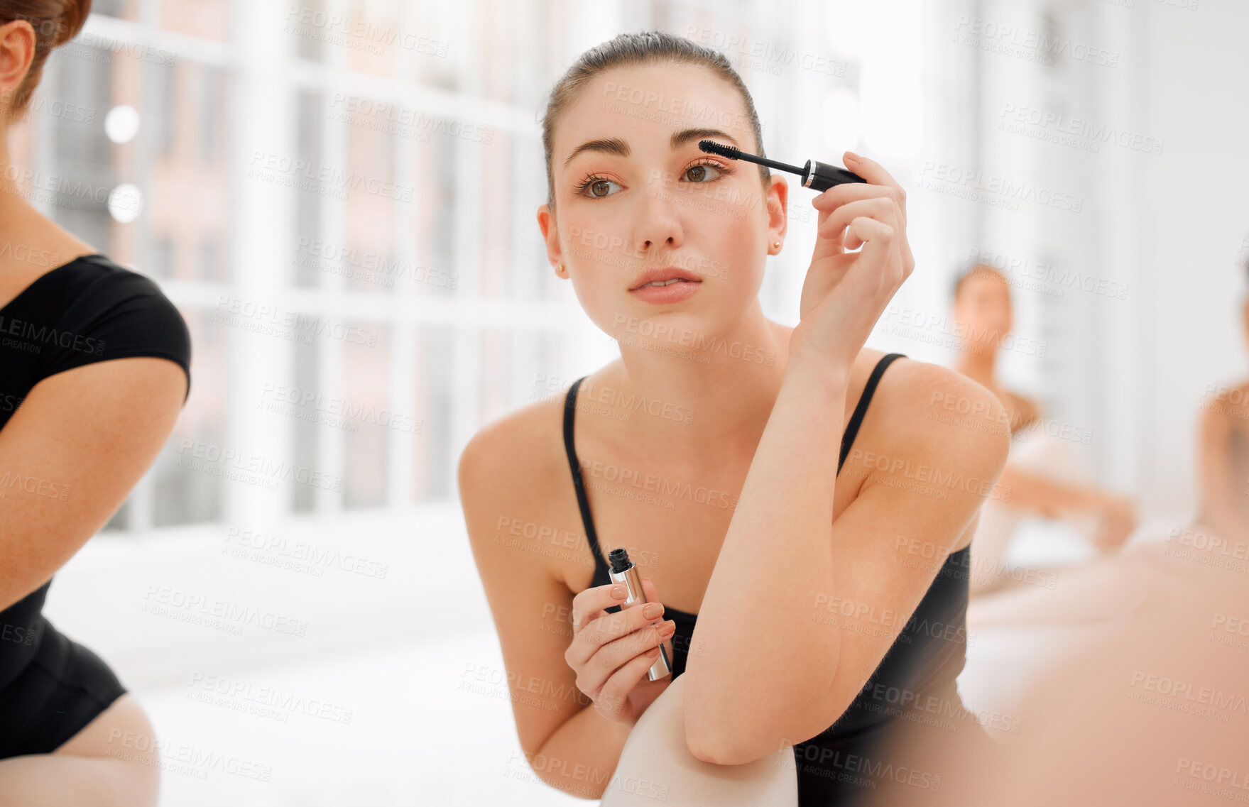 Buy stock photo Shot of a group of ballet dancers preparing to go on stage and applying makeup together in a mirror