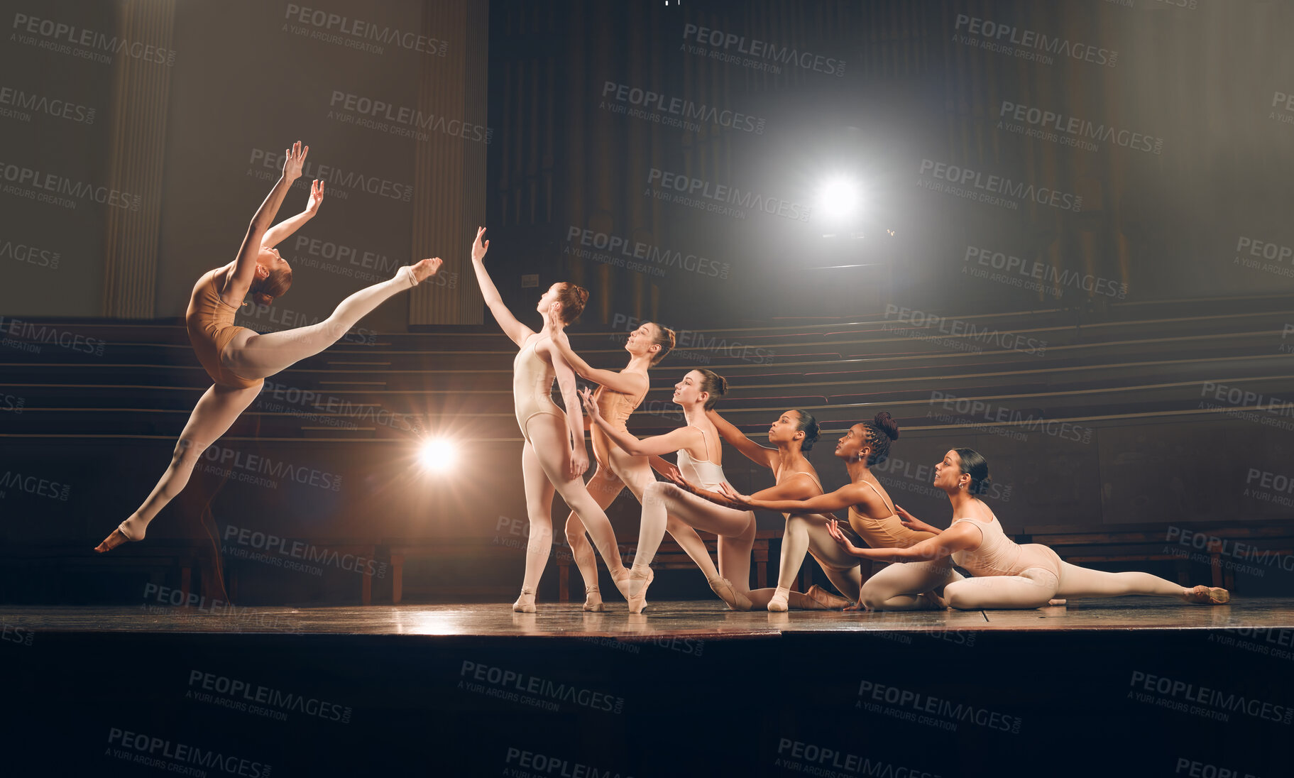 Buy stock photo Shot of a group of ballet dancers practicing a routine on a stage
