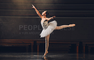 Buy stock photo Shot of a young woman practicing her routine in a stage