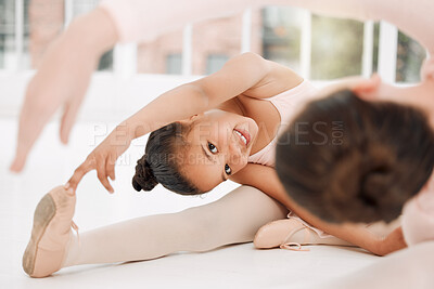 Buy stock photo Shot of a little girl stretching in a dance studio