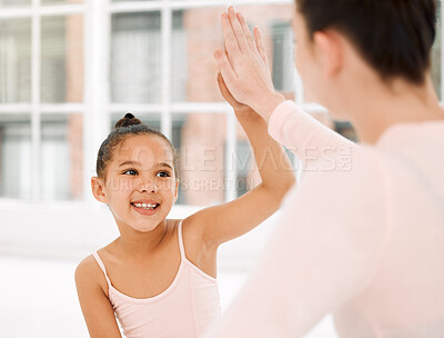 Buy stock photo Shot of a young ballerina and her teacher celebrating with a high five in a dance studio