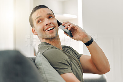 Buy stock photo Shot of a young man using a phone at home