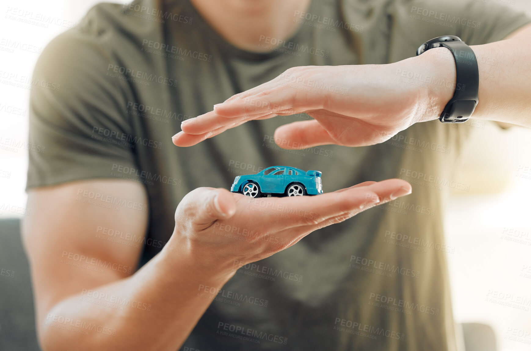 Buy stock photo Insurance, small car and hands of man at home for cover, investment and vehicle security. Person, toy automobile and shield in living room for accident policy, protection and warranty on purchase