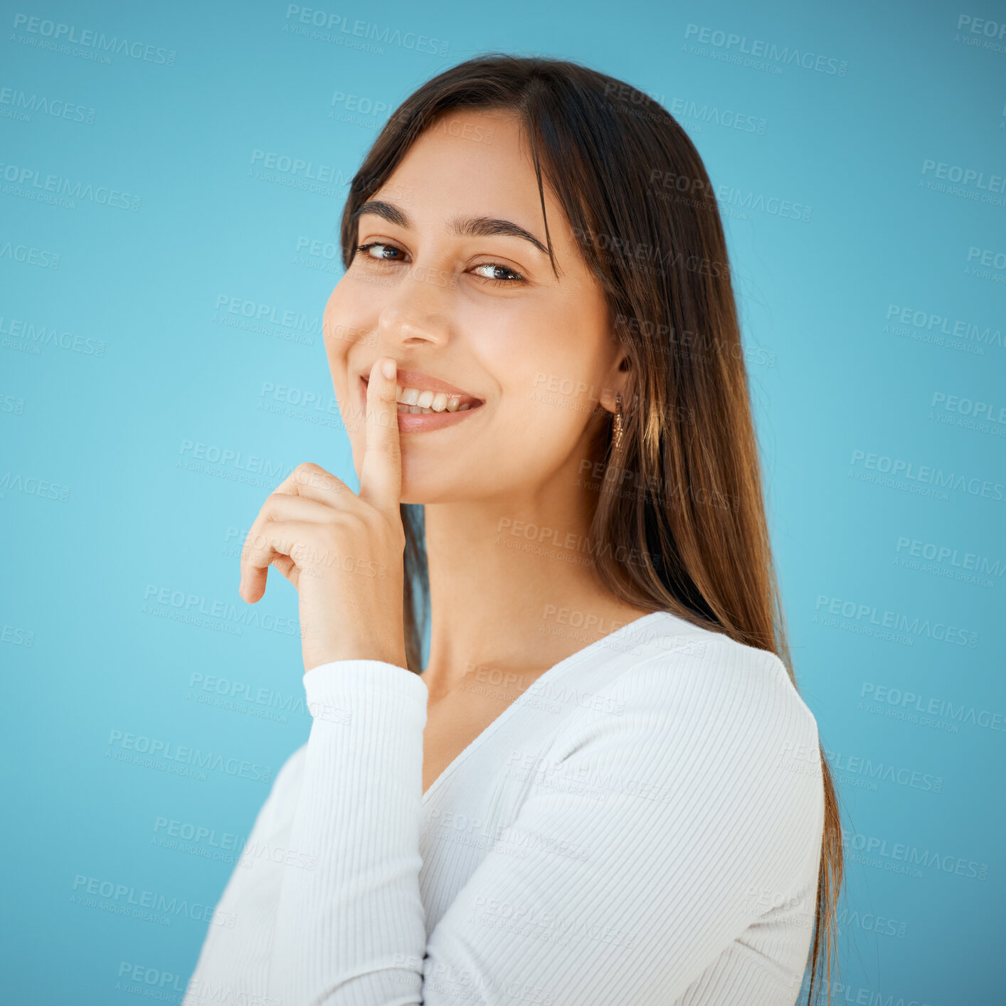 Buy stock photo Hush, portrait and smile with woman in studio isolated on blue background for gossip, mystery or secret. Emoji, privacy or voice of happy person with finger on lips for confidential, silence or quiet