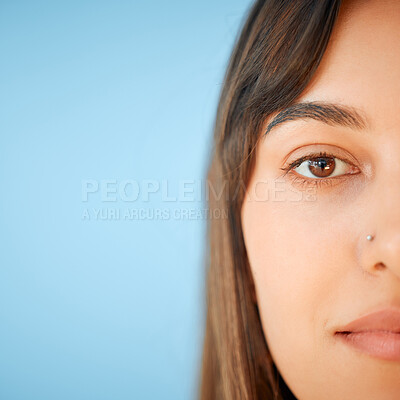 Buy stock photo Closeup portrait of a beautiful young woman against a blue background