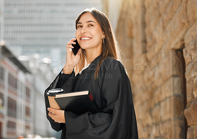 Buy stock photo Shot of a young female judge using her smartphone to make a call