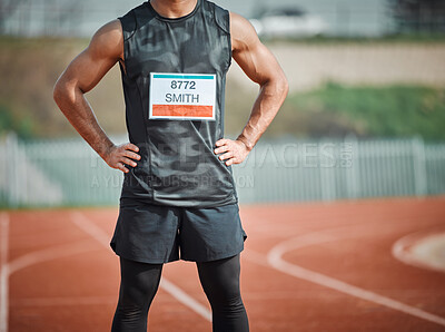 Buy stock photo Cropped shot of an unrecognizable male athlete standing out on the track with his hands on his hips