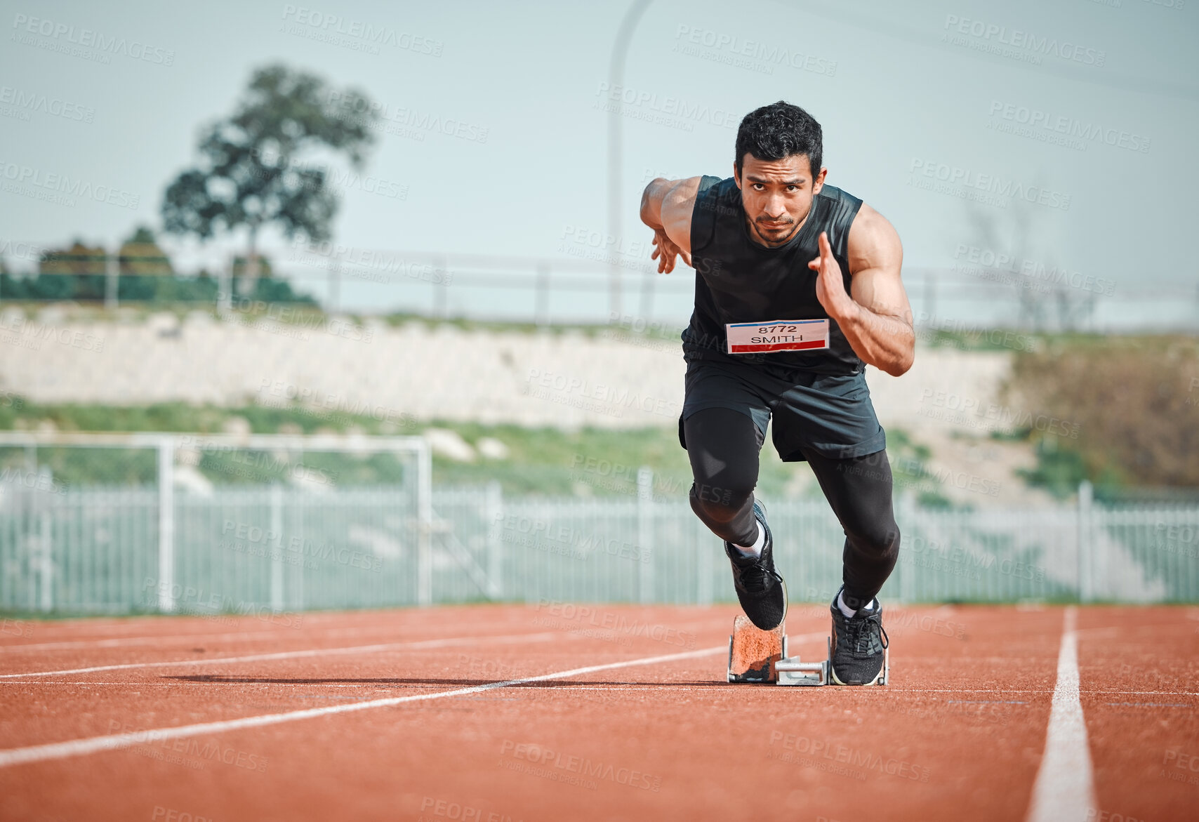 Buy stock photo Stadium focus, man running and athlete on a runner and arena track for sprint race training. Fast, run and sports exercise of a male person in marathon for fitness and cardio workout outdoor 