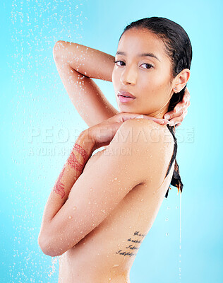 Buy stock photo Shot of a young woman enjoying a shower against a blue background