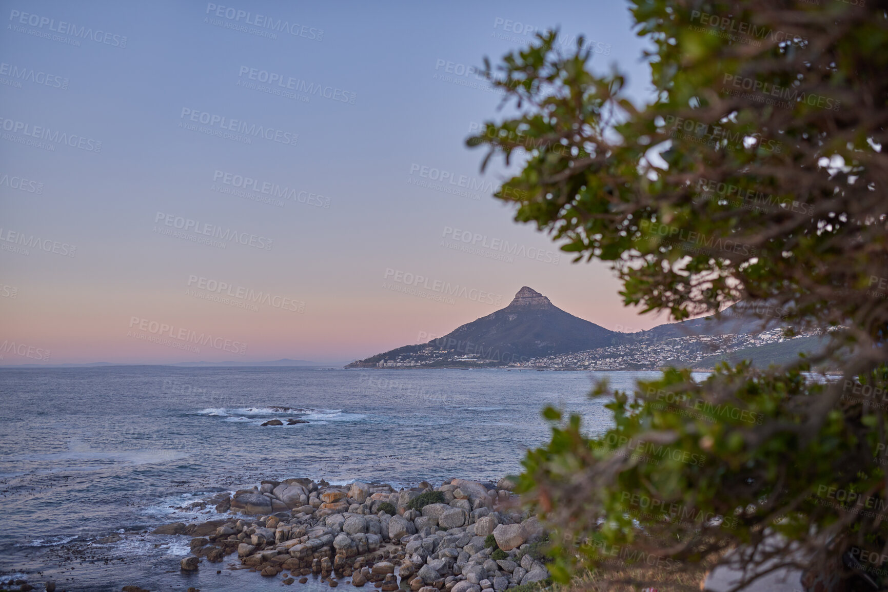 Buy stock photo Ocean view of sea water on rock beach, mountains and twilight sky with copy space of Lions Head in Cape Town, South Africa. Calm tide, serene or tranquil scenery of relaxing mother nature at sunrise