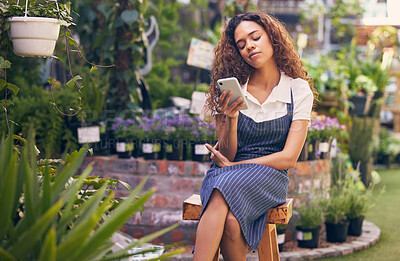 Buy stock photo Woman, florist and phone for online sales, ecommerce or shop order with serious face or worried of small business. Entrepreneur, gardener or seller typing on mobile of pot flowers or plants inventory